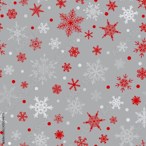 Christmas seamless pattern of snowflakes, red and white on gray background.