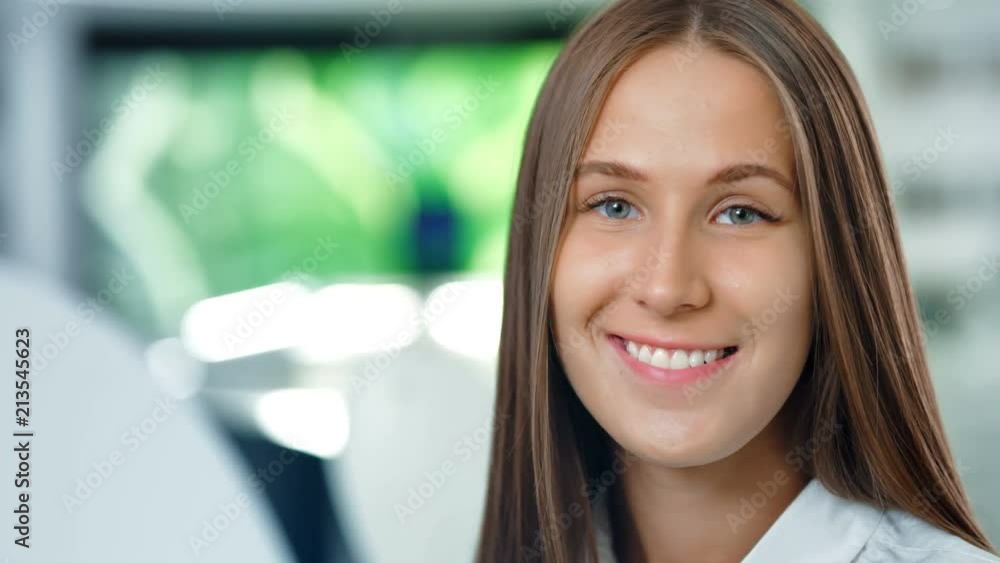 Portrait of attractive happy businesswoman in the modern office or lab. Future technologies concept Portrait of attractive happy businesswoman in the modern office or lab. Future technologies concept