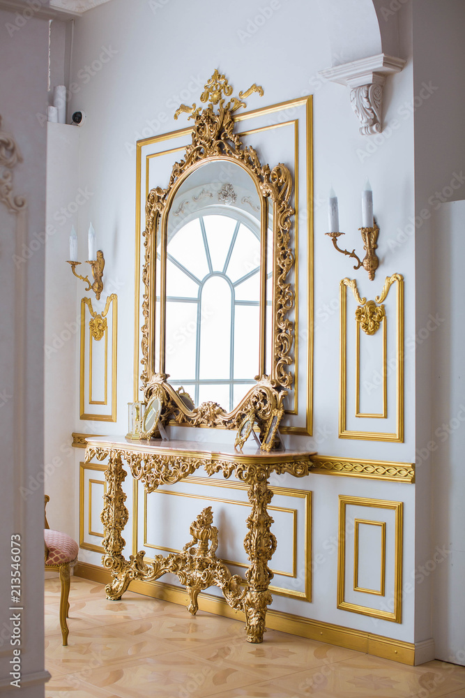 Luxurious table with large mirror in room Luxurious table with large mirror in room