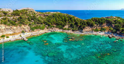 Fototapeta Naklejka Na Ścianę i Meble -  Aerial birds eye view drone photo Anthony Quinn and Ladiko bay on Rhodes island, Dodecanese, Greece. Panorama with nice lagoon and clear blue water. Famous tourist destination in South Europe