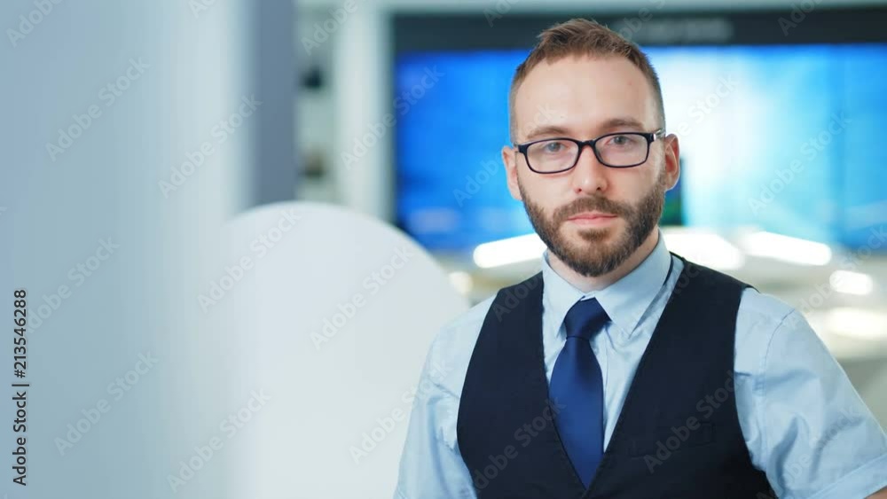 Portrait of confident businessman or programmer in the modern office or lab. Future technologies concept Portrait of confident businessman or programmer in the modern office or lab. Future technologies concept