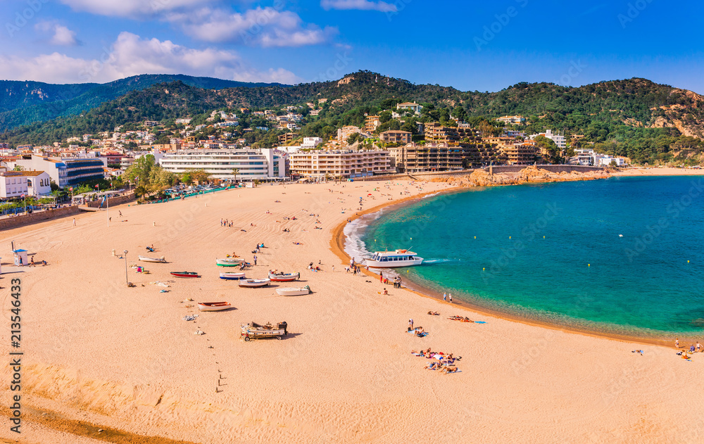 Sea landscape Badia bay in Tossa de Mar in Girona, Catalonia, Spain near of Barcelona. Ancient medieval castle with nice sand beach and clear blue water. Famous tourist destination in Costa Brava