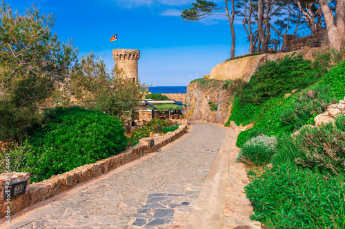 Castle in Tossa de Mar in Girona, Catalonia, Spain near of Barcelona. Ancient medieval castle with nice sand beach and clear blue water. Famous tourist destination in Costa Brava photo