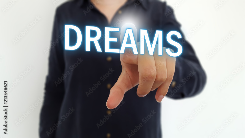 Businesswoman pointing finger on dreams text Businesswoman pointing finger on dreams text