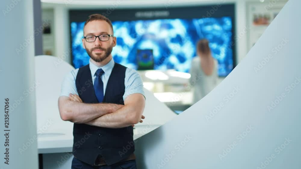 Portrait of confident businessman or programmer in the modern office or lab. Future technologies concept Portrait of confident businessman or programmer in the modern office or lab. Future technologies concept