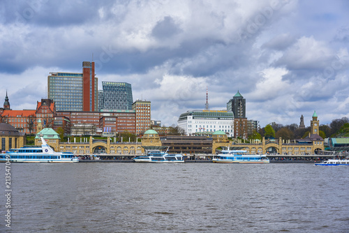 View of St. Pauli's Pier Landungsbrücken station tower with buildings and boats in Hamburg