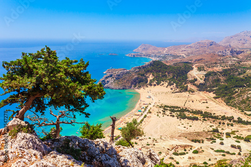 Sea skyview landscape photo Tsambika bay on Rhodes island, Dodecanese, Greece. Panorama with nice sand beach and clear blue water. Tsampika is a famous tourist destination in South Europe