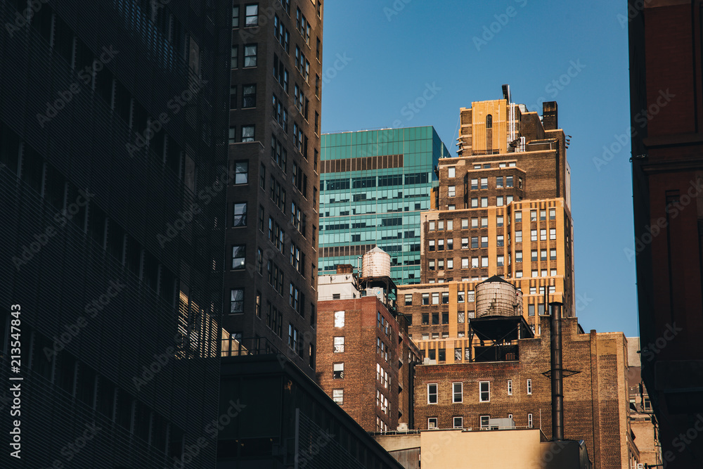 Fototapeta premium New York City / USA - JUL 13 2018: Skyscraper and old building view from street in midtown Manhattan