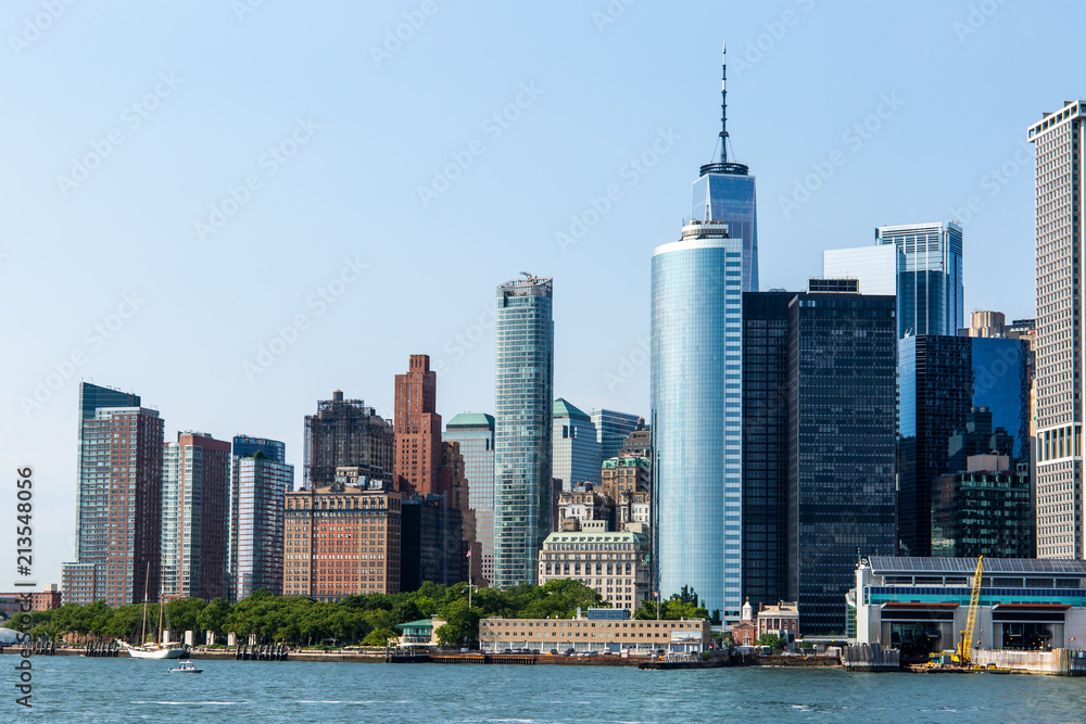 New York City / USA - JUL 14 2018: Lower Manhattan Skyline view from Governors Island ferry on a clear afternoon