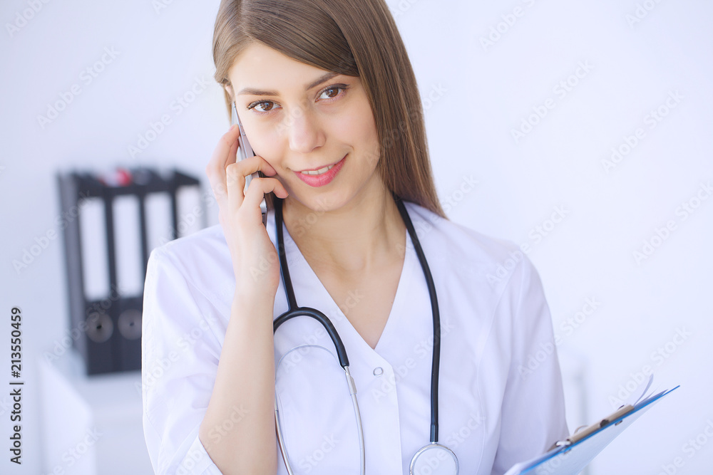Clinic. Medical physician female doctor over clinic interior background. Clinic. Medical physician female doctor over clinic interior background.