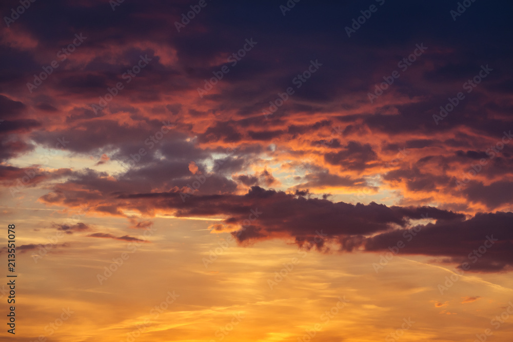 Dramatic red, orange and yellow clouds during sunset in Poland