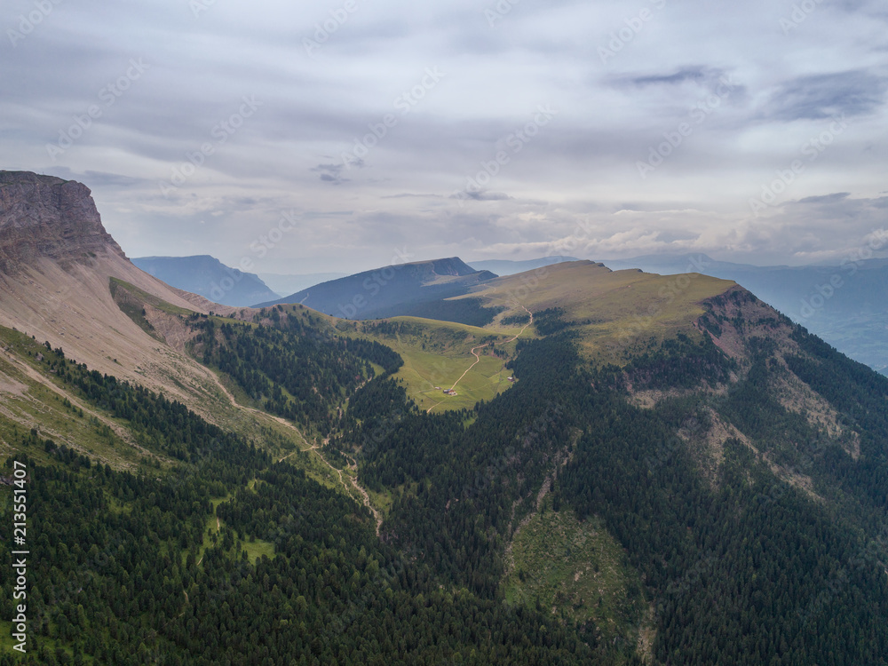 Aerial Drone photo of Santa Magdalena St Maddalena Val di Funes in Dolomites Italian Alps with Furchetta mountain peak on the background