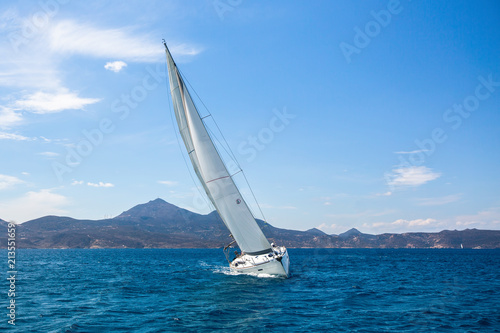 Luxury sailing yacht in the wind through the waves at the Aegean Sea.