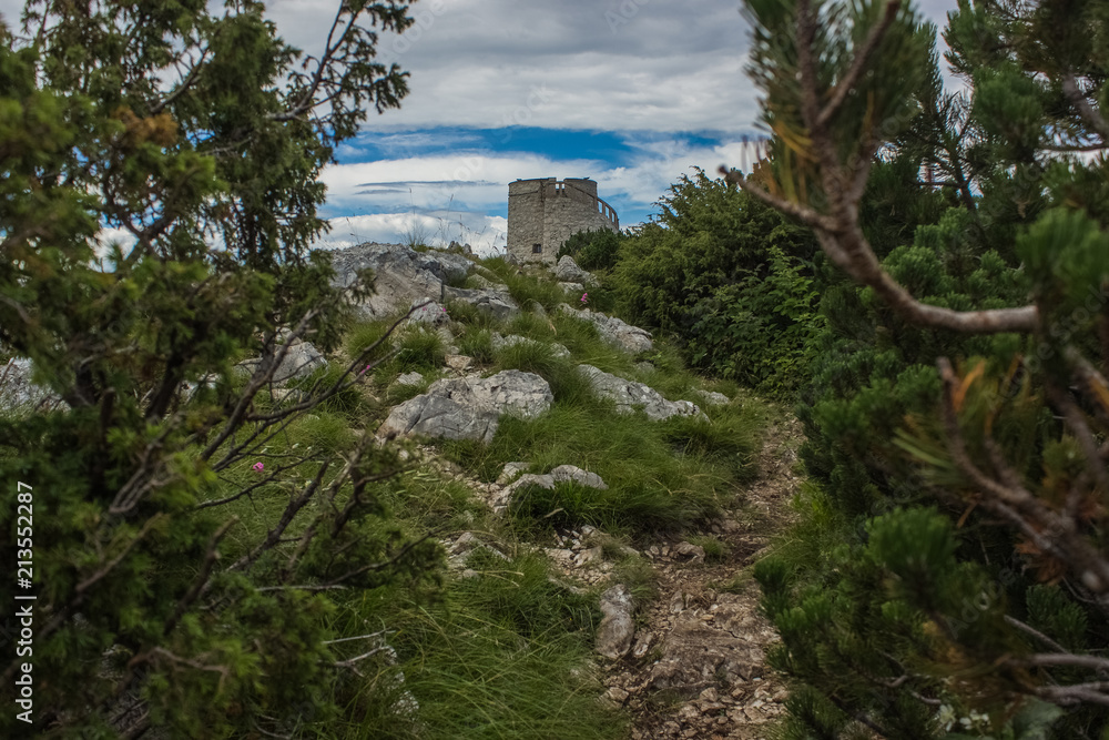 soft focus old medieval tower on top of high mountain nature landscape concept in colorful summer gray rainy day time 