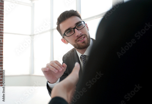 Two business colleagues sitting at a table, having a meeting