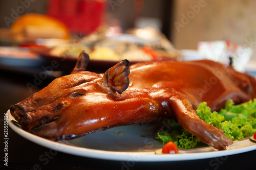 Delicious, Golden Roasted BBQ Suckling pig Cantonese Style made from a piglet that turned into Chinese delicacy which its cooked skin is very crispy and the meat is tender and juicy. Selective Focus.
