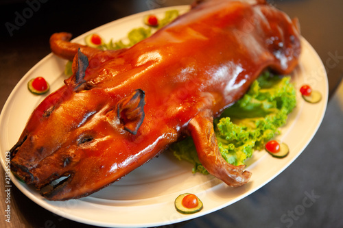 Delicious, Golden Roasted BBQ Suckling pig Cantonese Style made from a piglet that turned into Chinese delicacy which its cooked skin is very crispy and the meat is tender and juicy. Selective Focus.