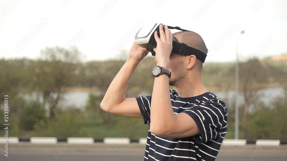 The young man uses the helmet of virtual reality for the first time.View images, video games.The world of virtual reality The young man uses the helmet of virtual reality for the first time.View images, video games.The world of virtual reality