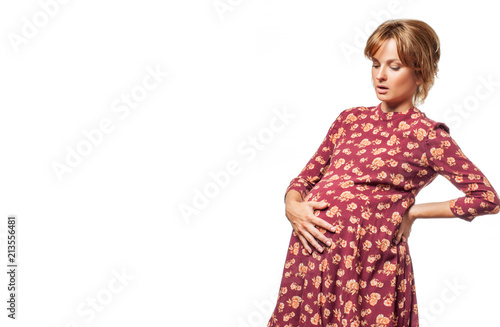 Happy pregnant woman touching her belly with hands.