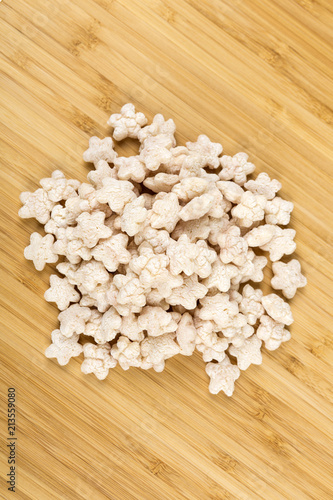 Piles of pale whole grain children's puffed cereal snack