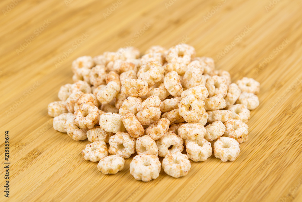 Piles of pale whole grain children's puffed cereal snack Piles of pale whole grain children's puffed cereal snack