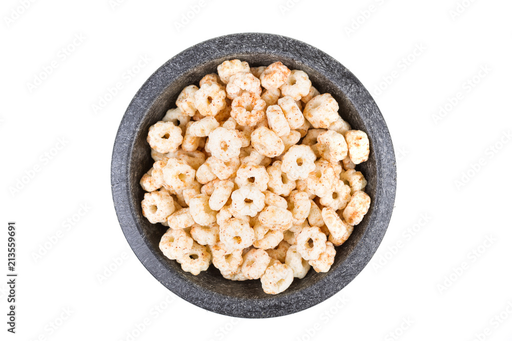Piles of pale whole grain children's puffed cereal snack Piles of pale whole grain children's puffed cereal snack