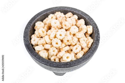 Piles of pale whole grain children's puffed cereal snack