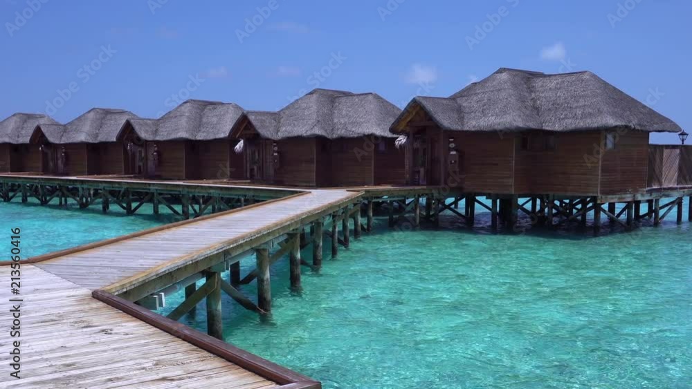 Tropical travel destination with pristine beach and water bungalows Tropical travel destination with pristine beach and water bungalows
