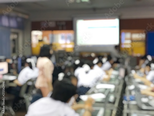 Blurred image of group of students are learning and lecture and using computer together in classroom for study and workshop in computers room at school. education technology or training concept.
