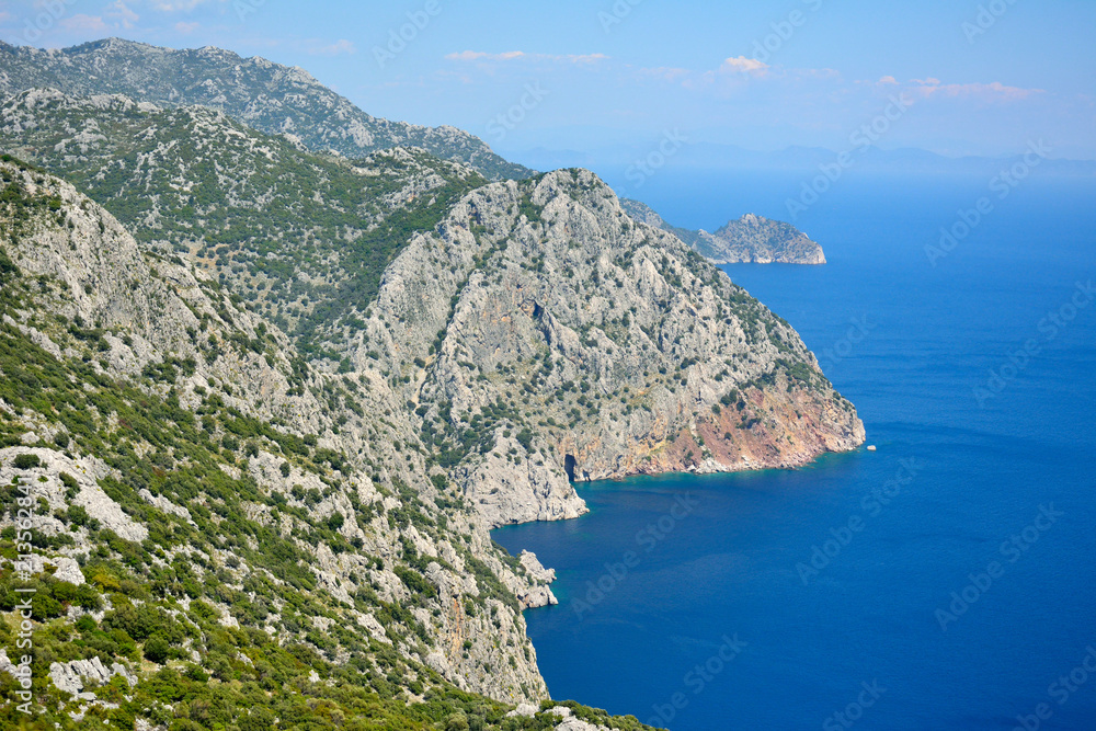 View toward cliffs hiding Ameliya beach on Bozburun peninsula near Marmaris resort town in Turkey.