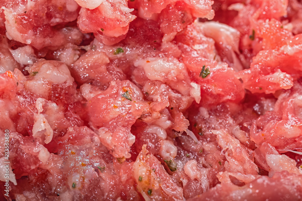 Raw mixed minced meat with herbs and spices made at home, close up. Raw mixed minced meat with herbs and spices made at home, close up.