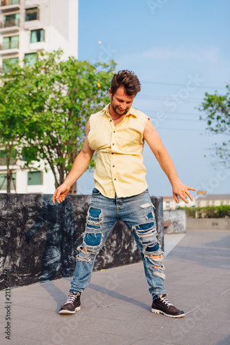 Young man dancing breakdance on the street. photo