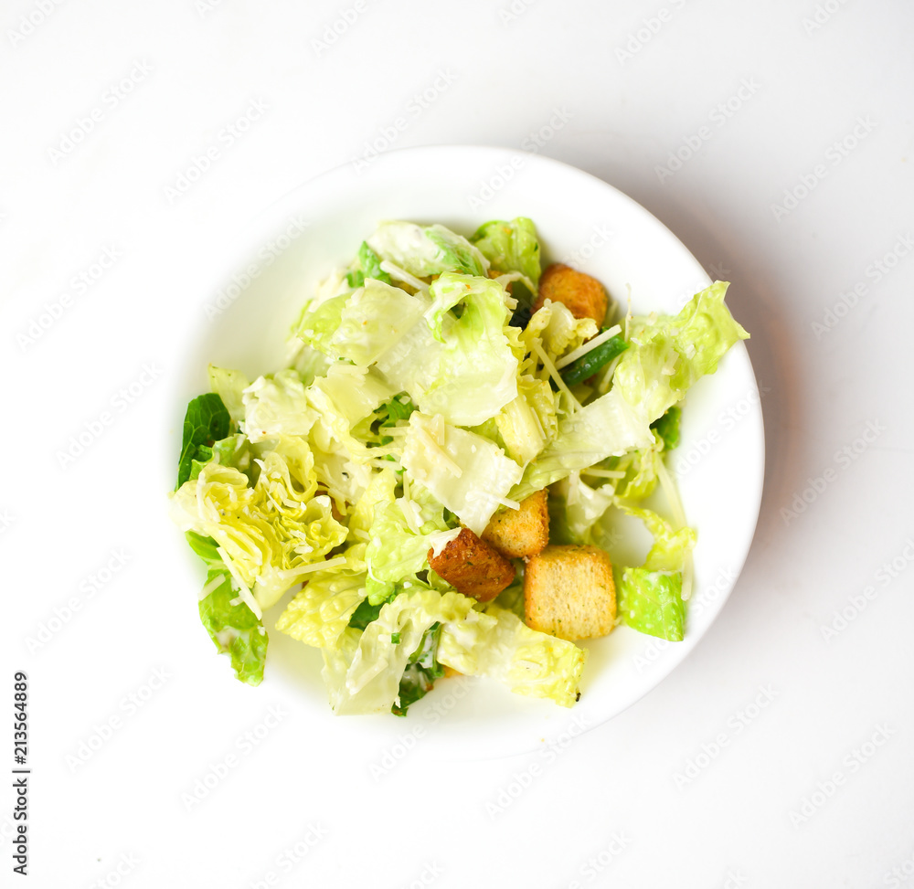 Caesar salad without chicken in a circular white bowl Caesar salad without chicken in a circular white bowl