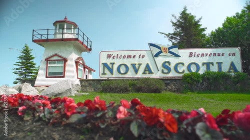Welcome to Nova Scotia sign with flower bed in foreground