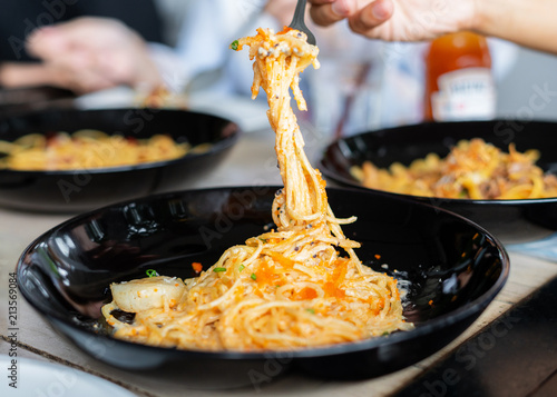 Spaghetti seafood. Hand using fork eating Spaghetti  