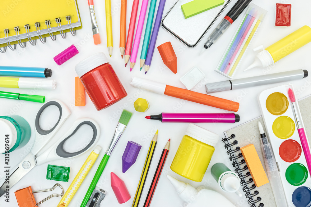 school supplies and stationary on white desk background. flat view