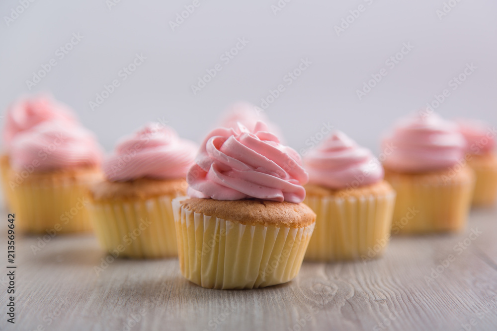 Tasty cupcakes on wooden table Tasty cupcakes on wooden table