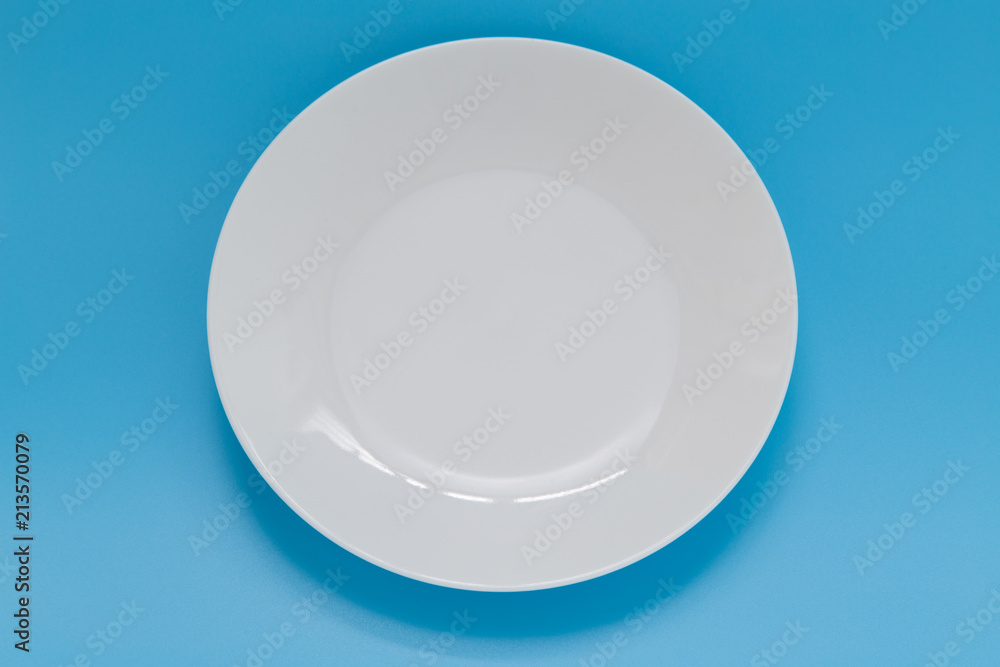 Empty dish top view on blue background. Empty dish top view on blue background.