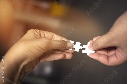 Partner Hand holding connecting piece jigsaw puzzle,Business connection,Success and strategy concept 