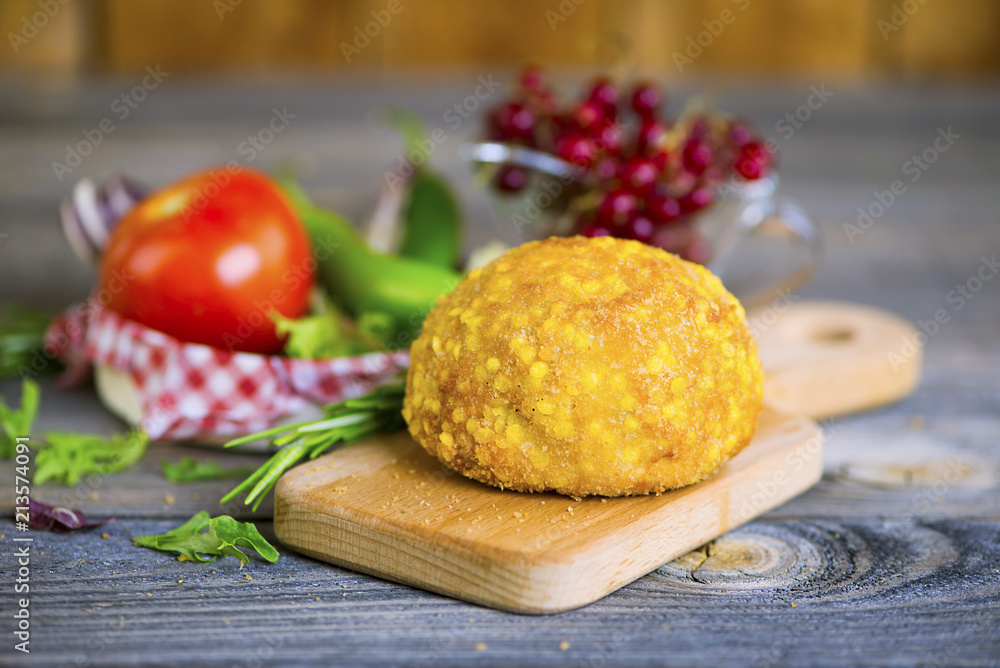 cutlet from turkey meat in batter on an old wooden background cutlet from turkey meat in batter on an old wooden background