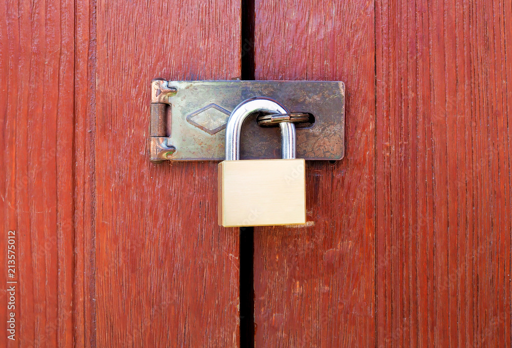 Locked padlock with chain at wooden door background, vintage, Closeup Locked padlock with chain at wooden door background, vintage, Closeup