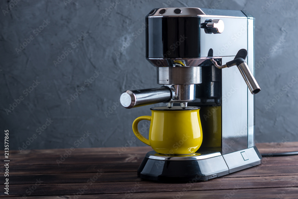Preparation of espresso. Black coffee machine on the table. Professional coffee brewing Preparation of espresso. Black coffee machine on the table. Professional coffee brewing