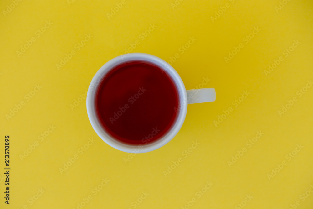 Cup of tea on a yellow background top view. - obrazy, fototapety, plakaty 