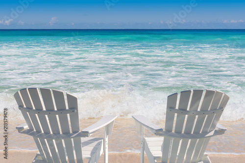 Beach chairs on sandy beach and turquoise sea.  Summer vacation and travel concept.   © lucky-photo
