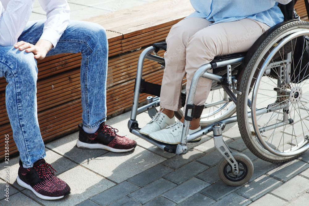Woman in a wheelchair using a ramp Woman in a wheelchair using a ramp