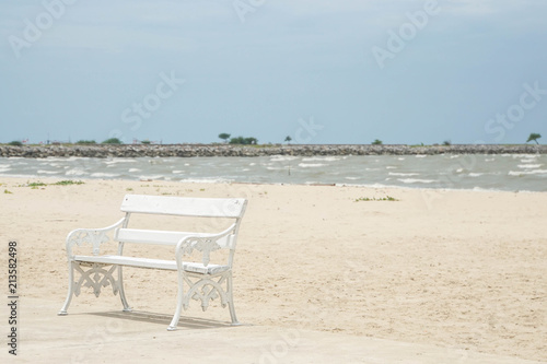 peace concept of white wooden bench for seat at seaside on the beach