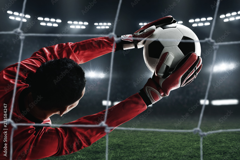 Naklejka premium Soccer goalkeeper catches the ball