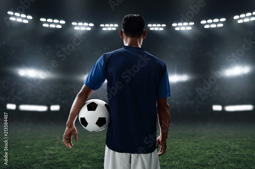 Soccer player holding soccer ball
