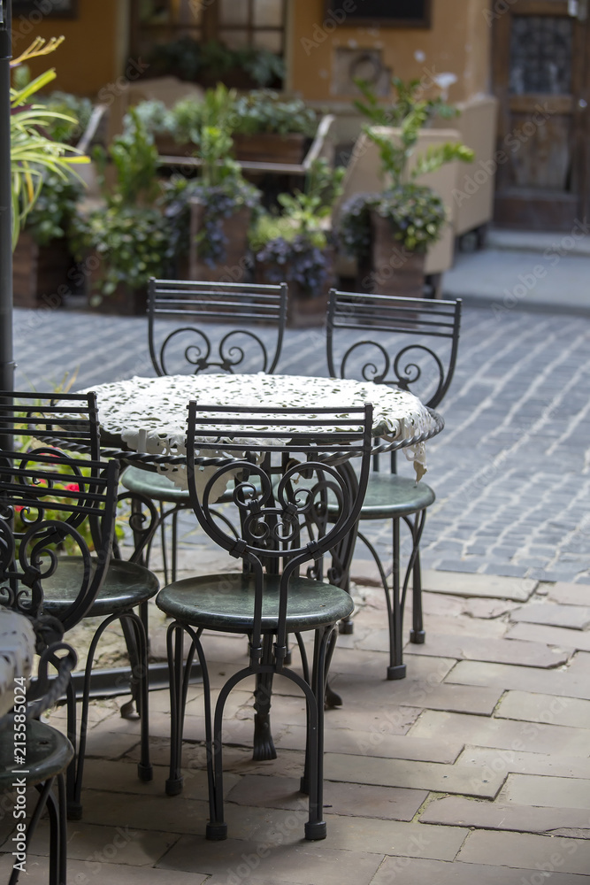 Empty tables and chairs on outdoor street cafe in city center of Lviv, Ukraine