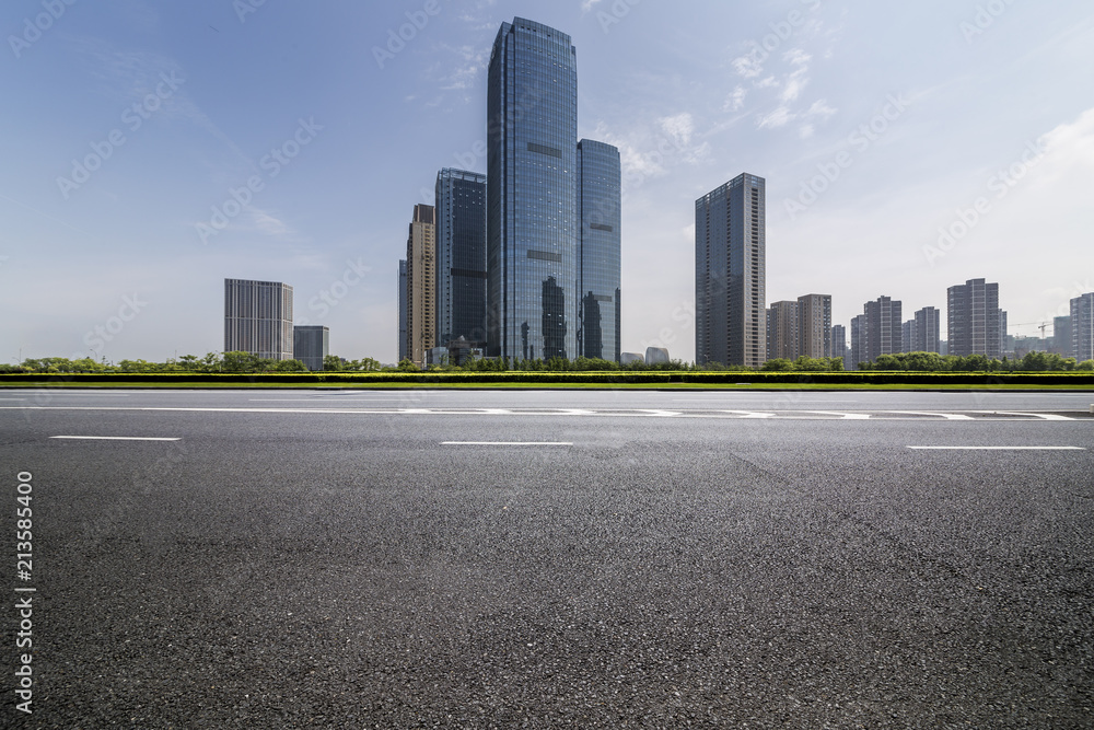 Panoramic skyline and modern business office buildings with empty road,empty concrete square floor Panoramic skyline and modern business office buildings with empty road,empty concrete square floor